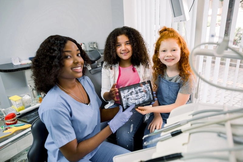 shot-of-professional-female-african-dentist-and-he-2024-12-13-11-44-23-utc