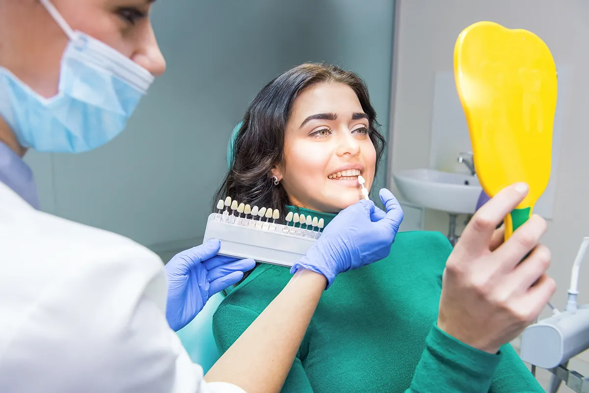 A dental professional providing care instructions for dental implants to a patient.